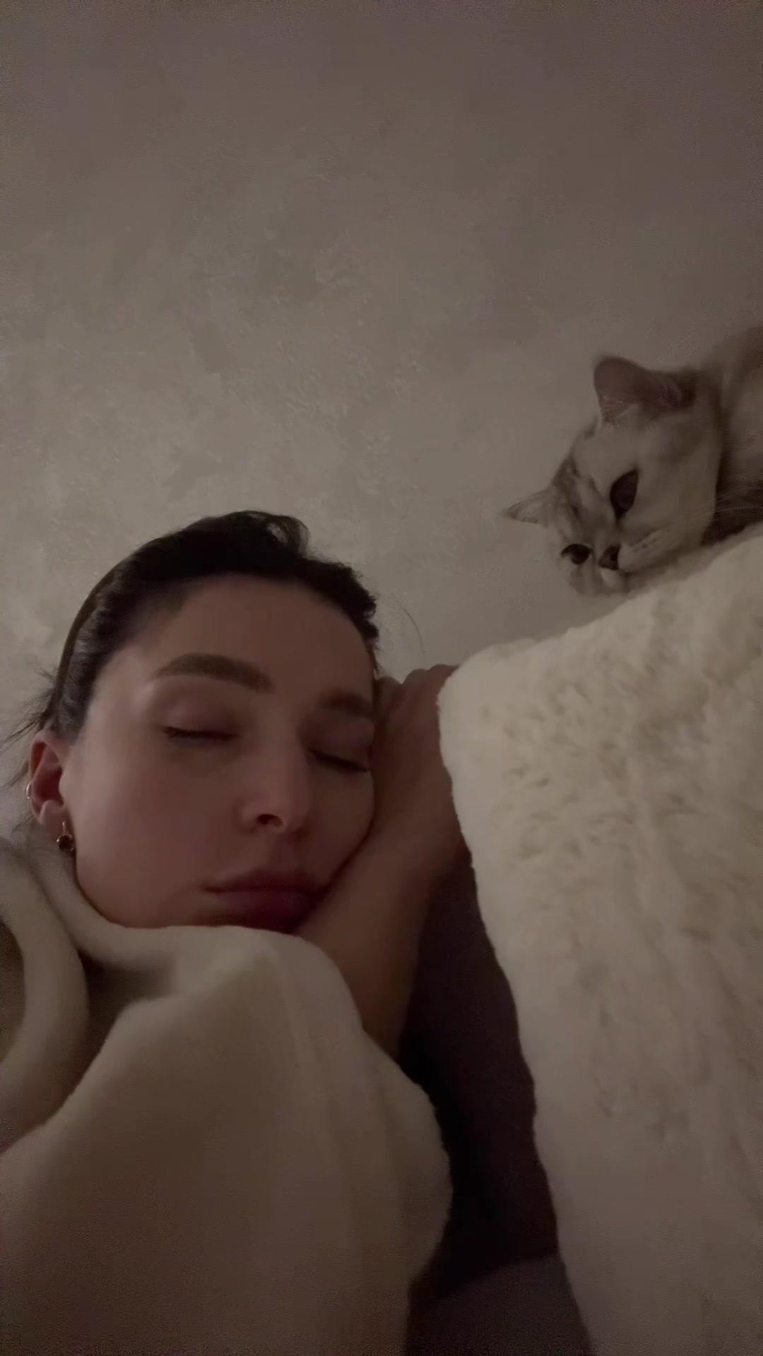 Woman Resting in Bed with Pet Cat