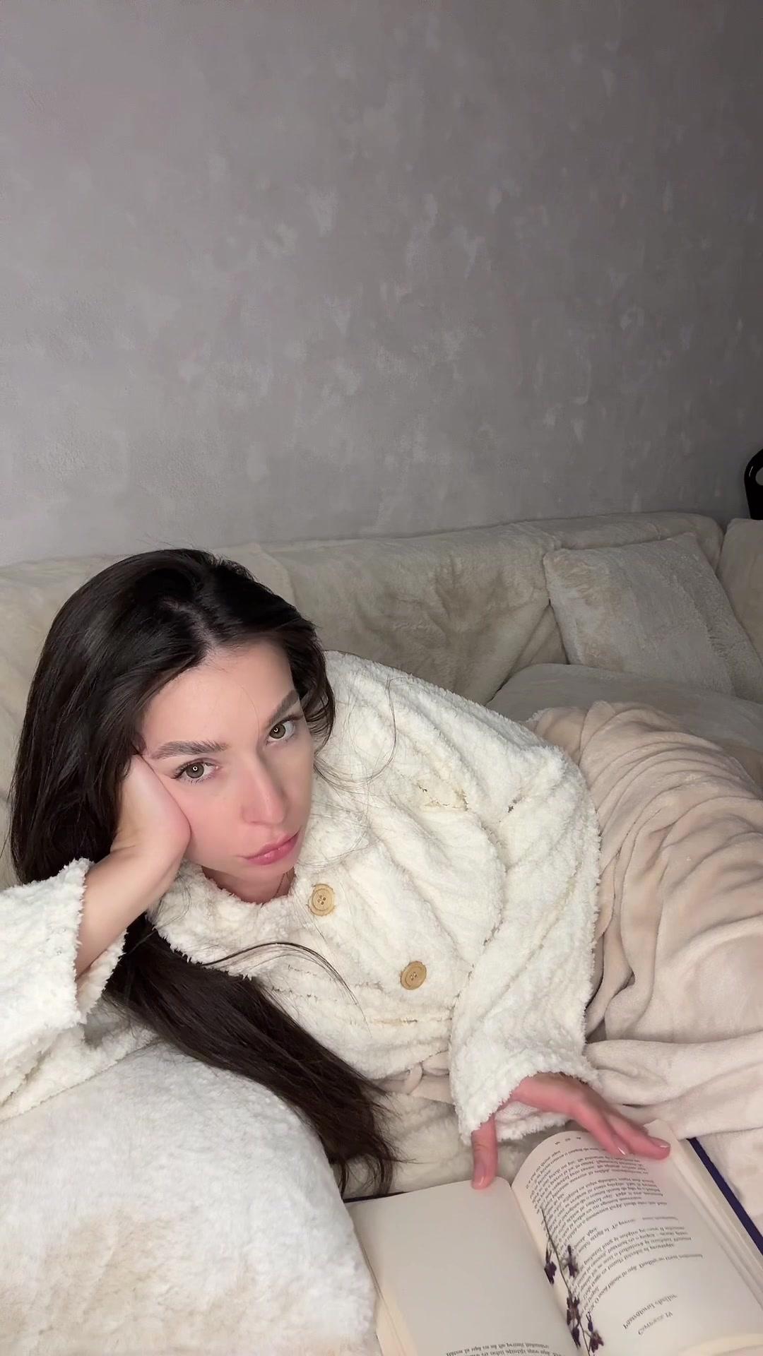 Cozy Woman Reading Book on Sofa