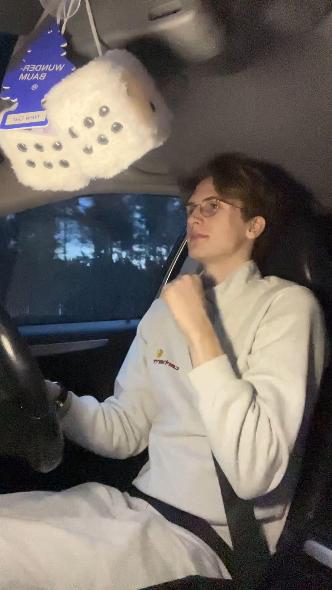 Man happily singing in car