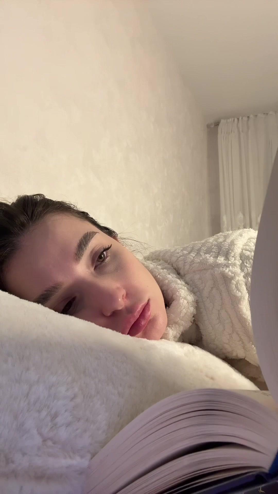 Young Woman Shocked While Reading in Bed