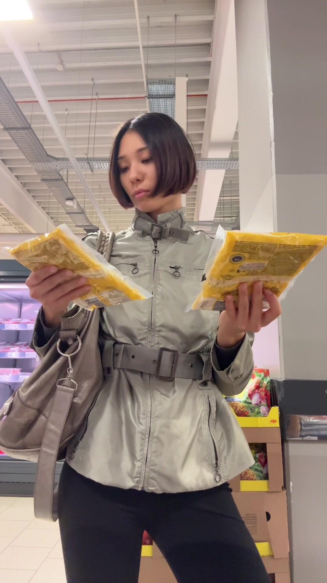 Woman Comparing Food Packages in Store