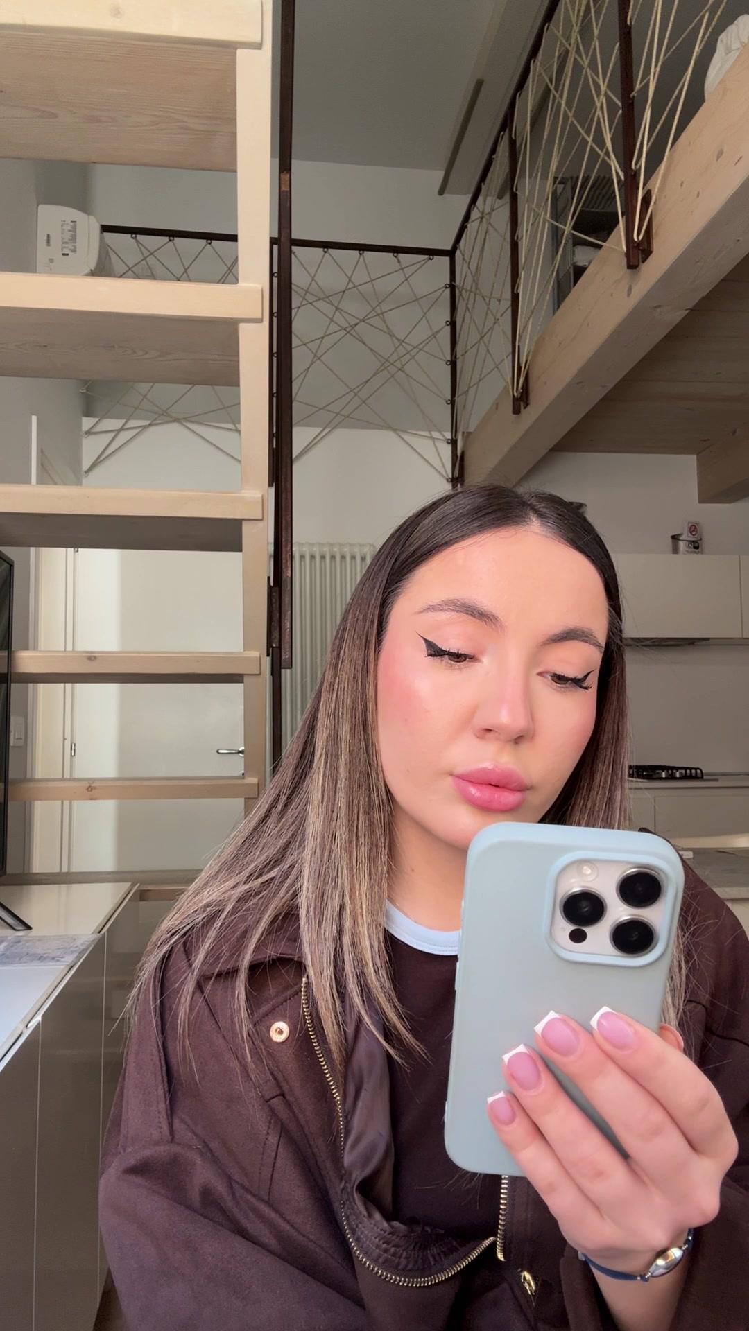 Girl Softly Smiling at Phone