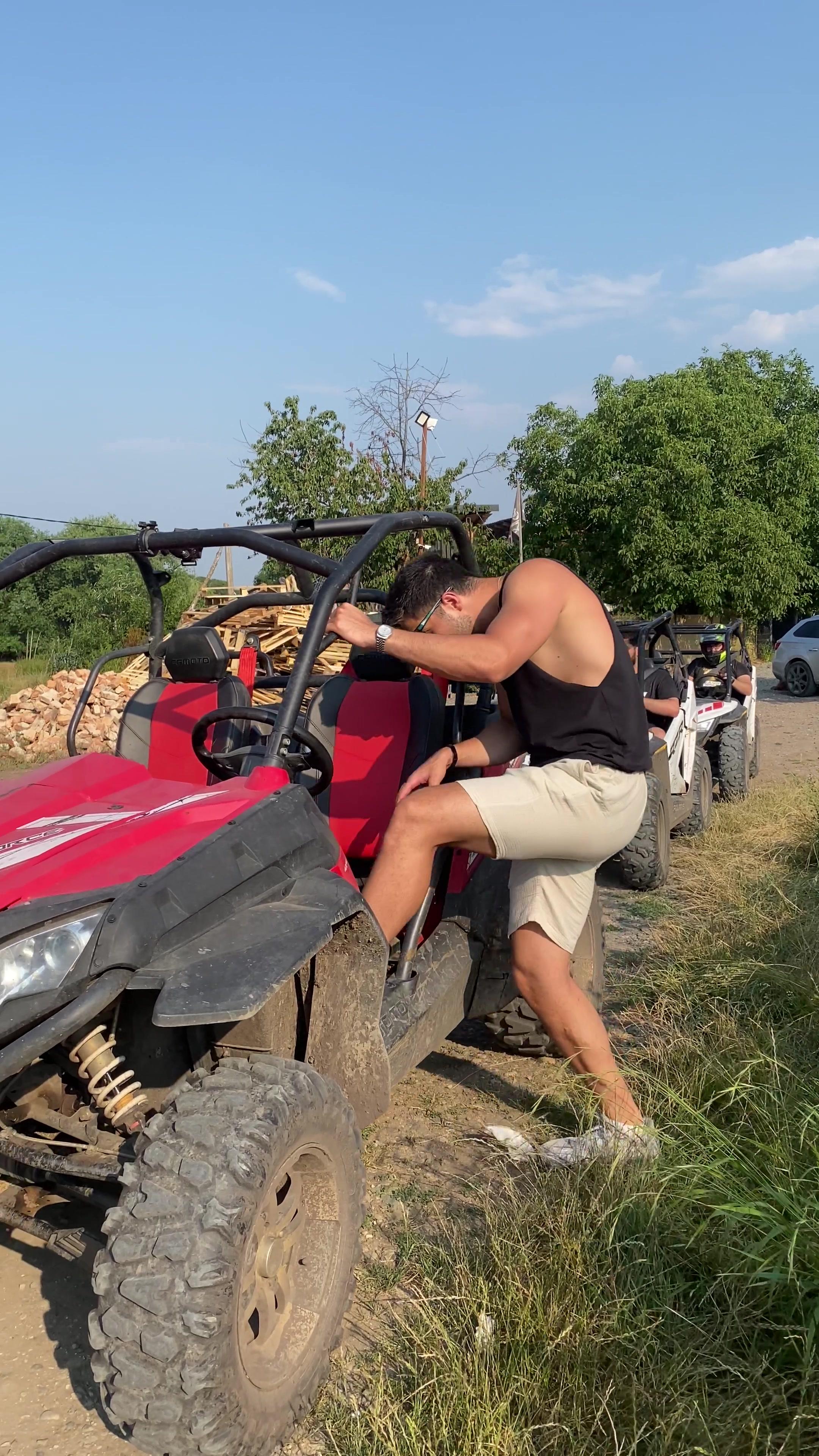 Young Man Getting Into Red Off-Road Buggy