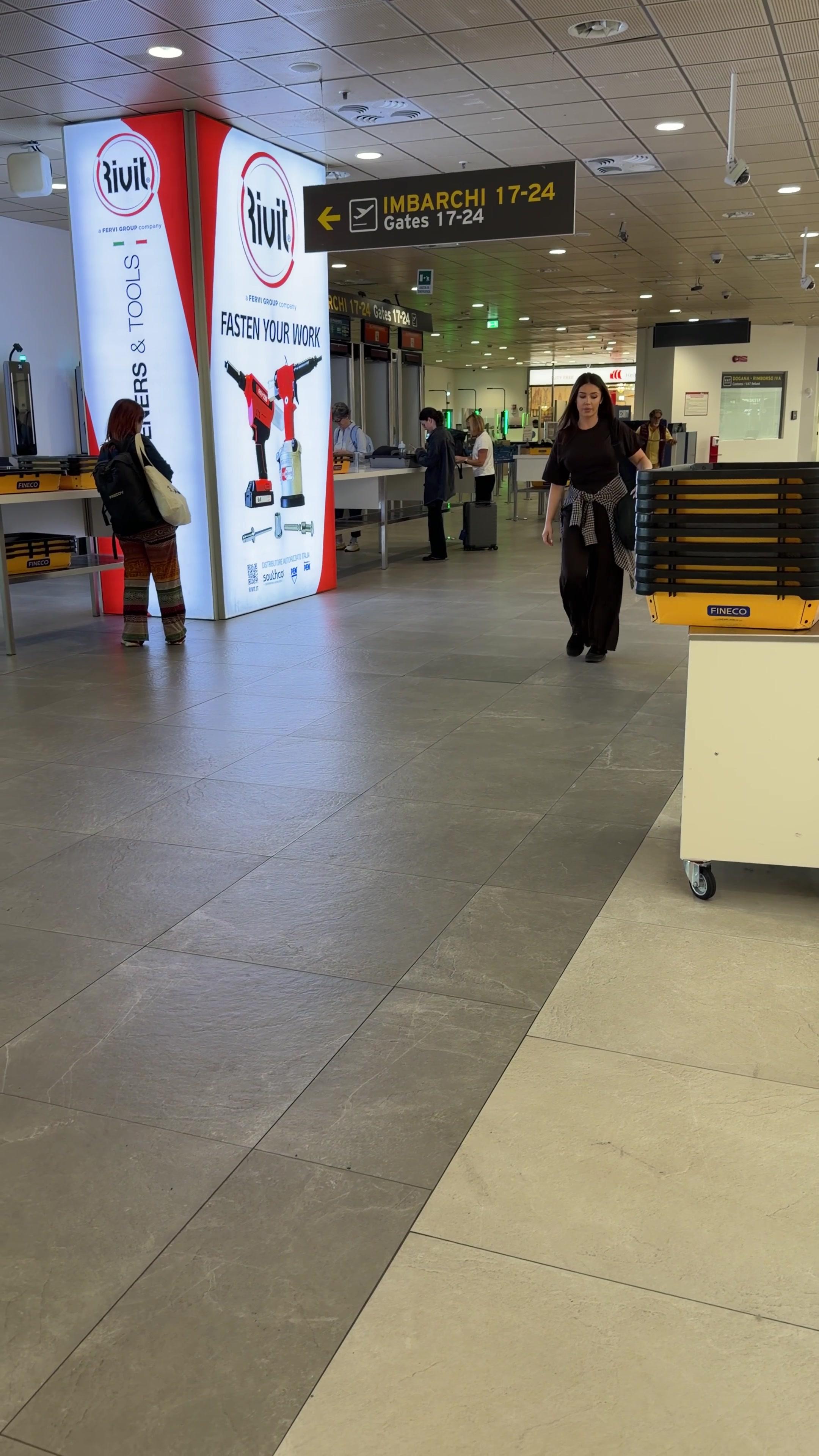 Woman Walking Through Airport Terminal